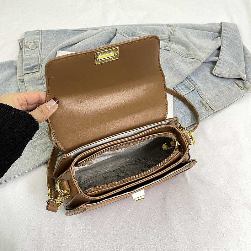 Spring niche design fashionable contrasting color saddle bag portable shoulder crossbody trendy women's bag
