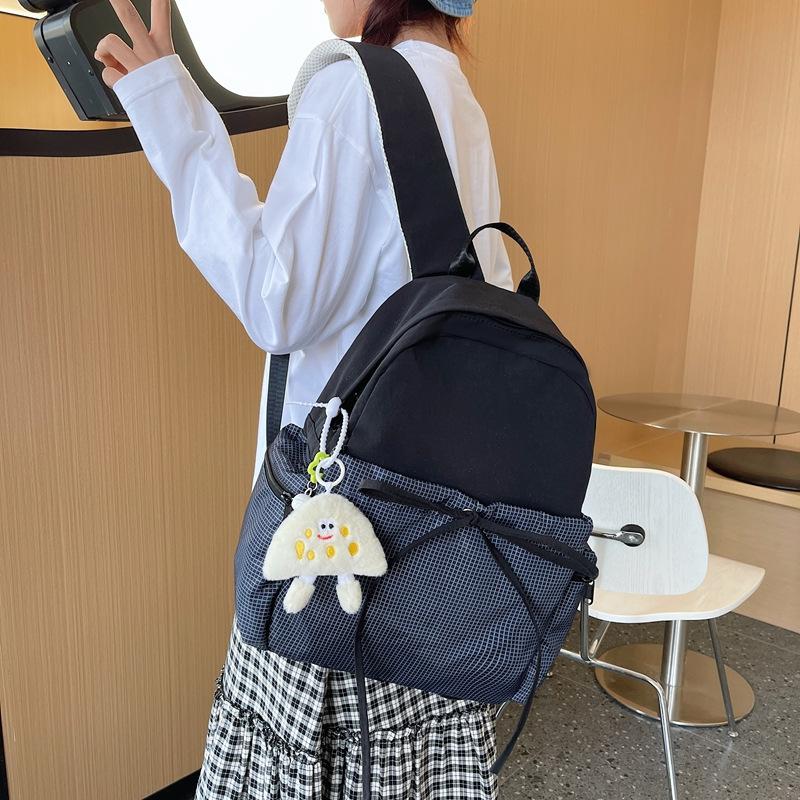 High-value bow ins niche plaid schoolbag for female junior high school students, casual and lightweight college students, travel backpack.