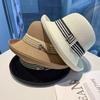 Le nouveau chapeau de paille pour femme en tissu rayé avec bordure ondulée chapeau de plage et de voyage avec bordure noire