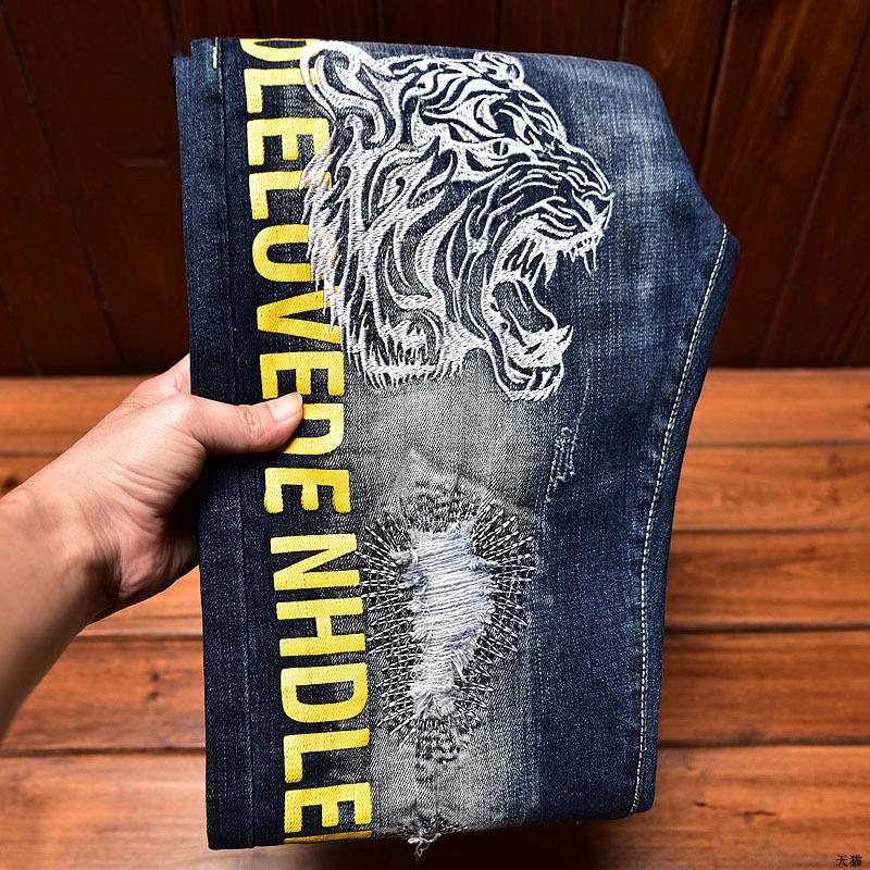 Men's Slim-Fit Embroidered Floral Distressed Jeans with Patches and Elastic Trim.