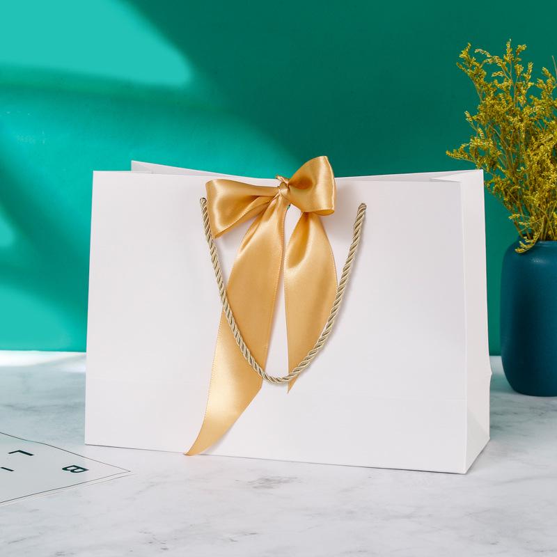 In-Stock White Cardboard Gift Bags with Bow Handle, Customizable Logo for Clothing Stores