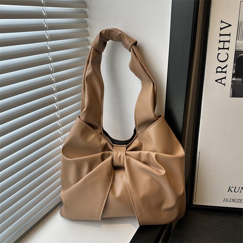 Korean version of casual underarm women's bag 2025 new simple bow design sense tote bag simple portable shoulder bag
