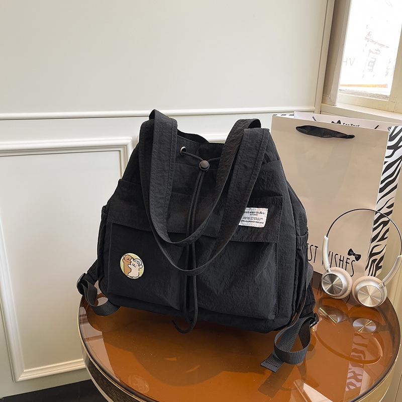New backpack Korean version of women s niche drawstring backpack large capacity nylon light commuter portable shoulder bag