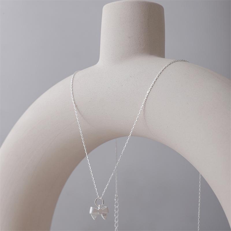 Charming Christmas Bow Pendant Necklace: Simple, Frosted Clavicle Chain for Women - Autumn Light Luxury Choker