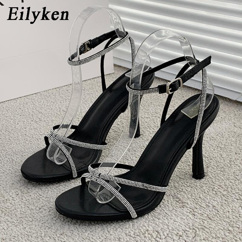 

Eilyken Дизайн одежды CRYSTAL Пряжки Высокие каблуки Сандалии Женщины Peep Toe Clip-On Strappy Лодыжка Ремешок Шест Танцы Женщины обувь