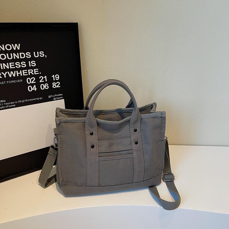 

Korean version of trendy handbag women s 2025 new fashion canvas shoulder messenger women s bag commuter casual tote bag сірий колір