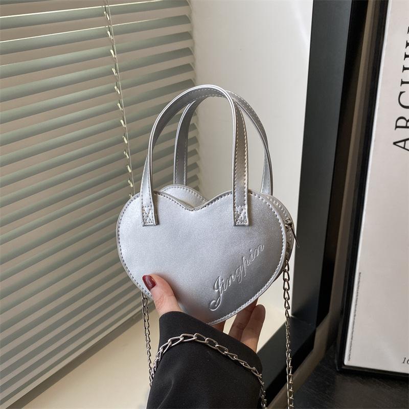 

Spring and summer new niche solid color casual versatile handbag love peach heart bag shoulder messenger bag women серебряный