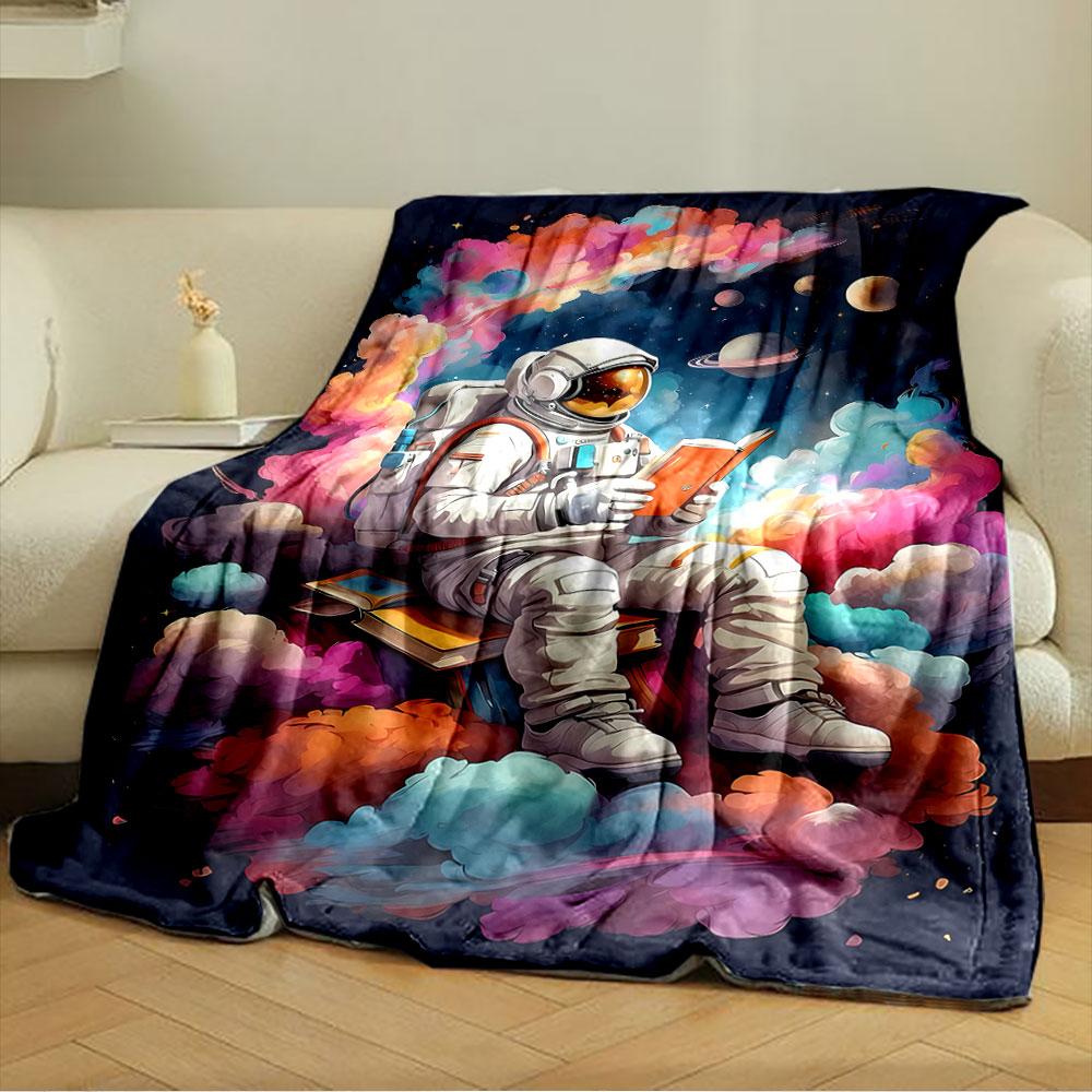 An Astronaut Reads a Book Amidst Colorful Clouds and a Space Backdrop. for All Seasons Blanket Lunch Break Throw Gift