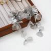 Silver Rhinestone Fishtail Tassel Earrings: Exaggerated Flower Design for a Stylish Look.