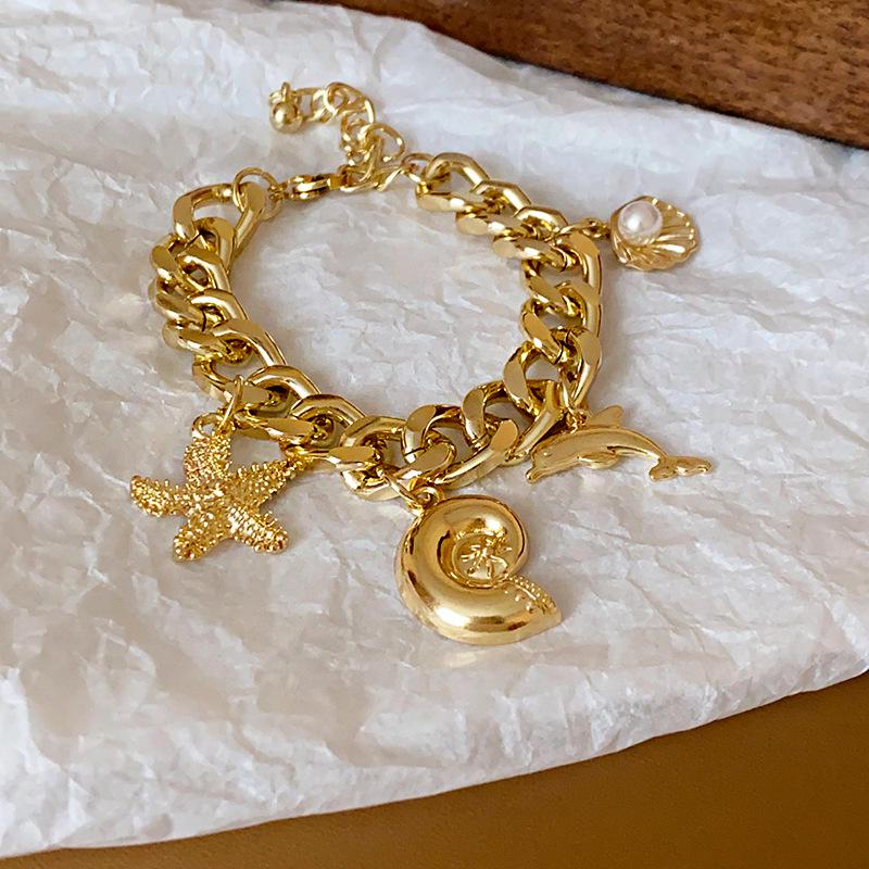 

Элегантный браслет с дельфином, морской звездой, ракушкой и жемчугом: Высококлассный минималистичный браслет для женщин