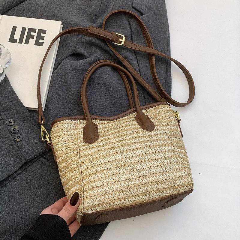 

2025 new niche design contrasting colors straw hand-held bucket bag leisure commuting vacation wind messenger beach bag women