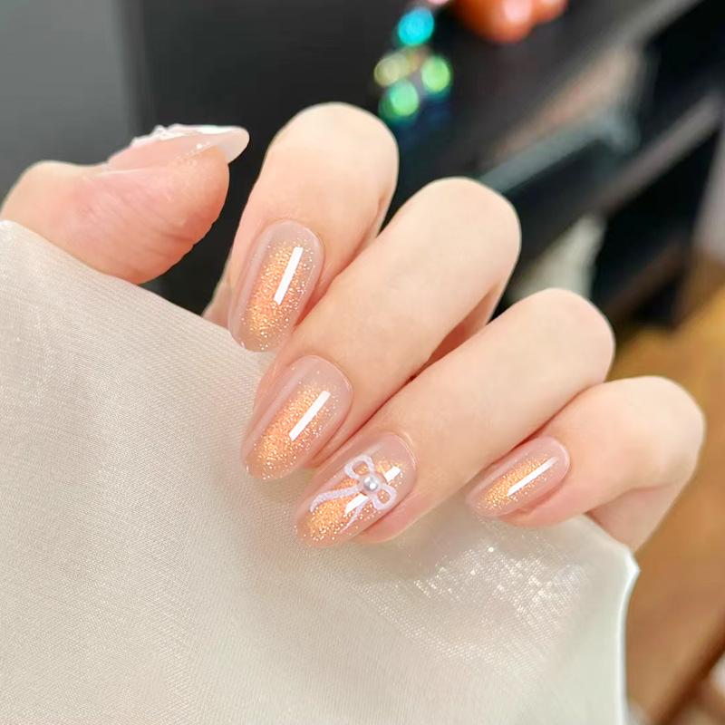 

Asaka Gold Ombre Almond Wearable Nails with Bow & Pearl Accents Glue Kit