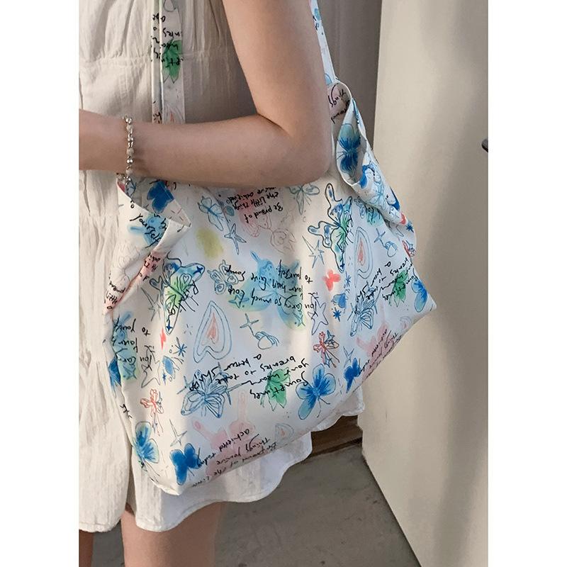 

Summer butterfly graffiti canvas bag women s 2025 new fashion tote bag casual large-capacity floral cloth bag