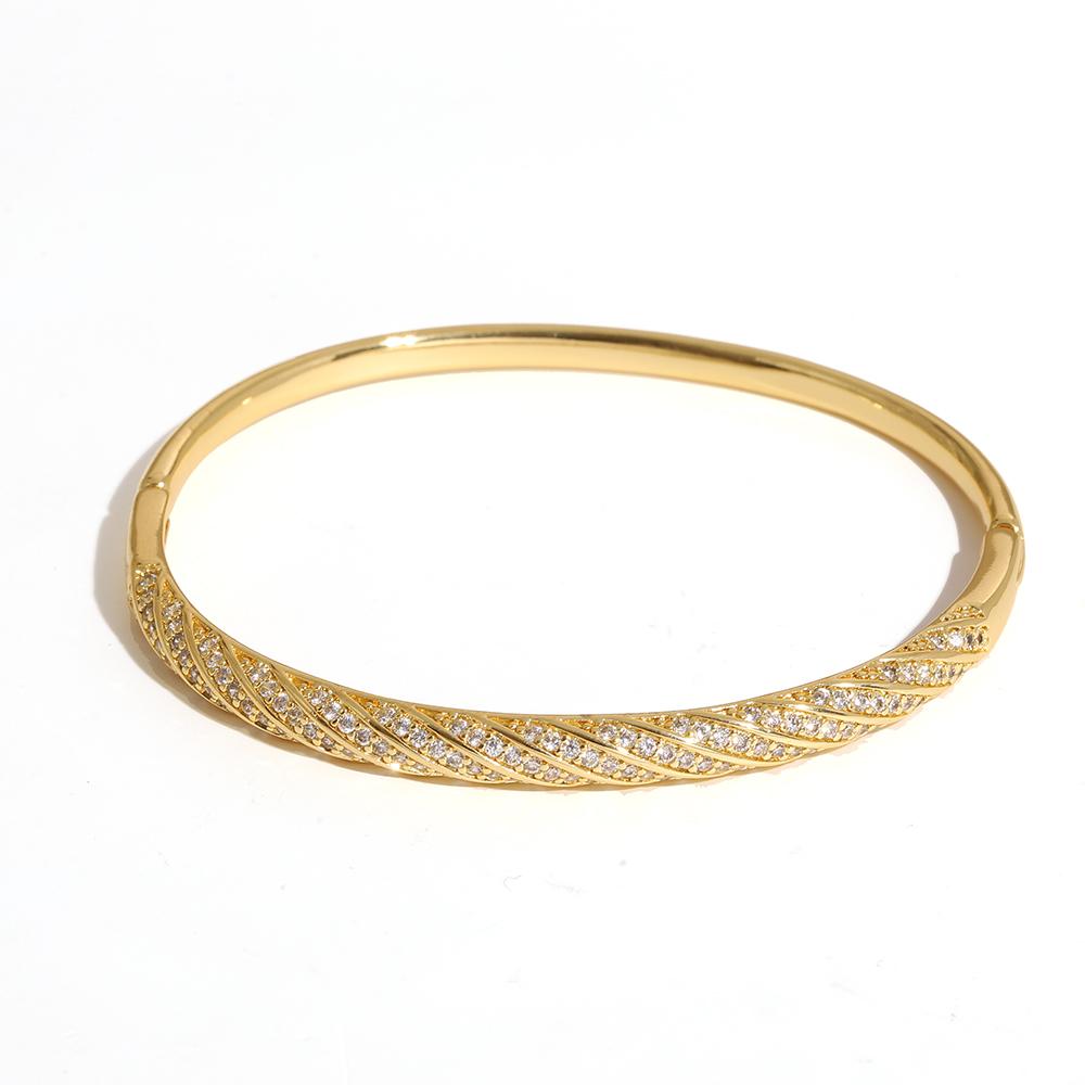 Luxuriöses funkelndes Strass-Armband, goldplattiert, für Damen, exquisites unregelmäßiges geometrisches Schleifenmanschetten-Federarmband Schmuck