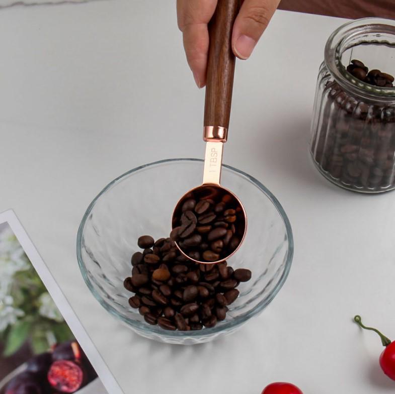 Gold-Plated Stainless Steel Measuring Cups & Spoons with Solid Wood Handles and Scale Markings for Baking.