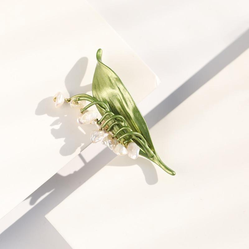 Vintage seashell brooch with baroque natural freshwater pearl and lacquered tree leaf detail