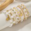 9-teiliges Bohemian-Stil Öl-Tropfen Gänseblümchen Anhänger Armband, mehrlagiges Weichkeramik-Blumen Imitation Perlen Armband Set