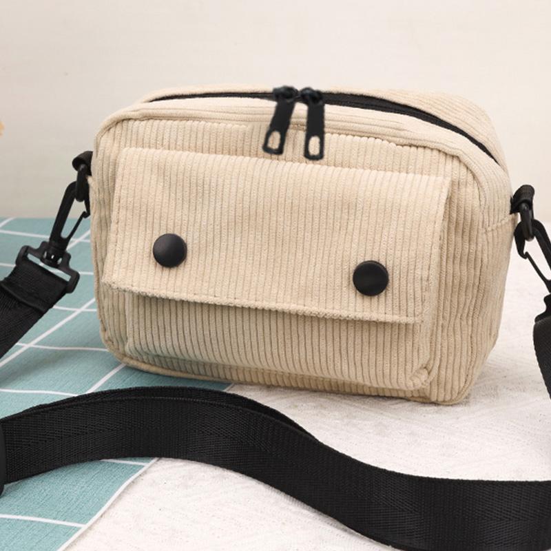 Neutral men's and women's cross-body bag with shoulder strap, made of corduroy material, with a flap design  the outside.