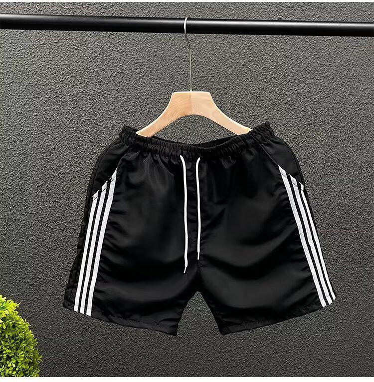 

Чоловічі швидковисихаючі спортивні штани в смужку три чверті L чорний