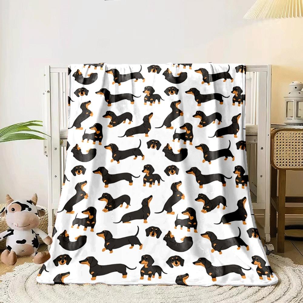 The pattern features repeating illustrations of black and tan dachshunds. for all seasons blanket lunch break throw gift 80cm x 120cm