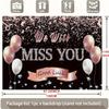 A photo backdrop for a retirement farewell celebration featuring a rose gold banner that reads "We will miss you"