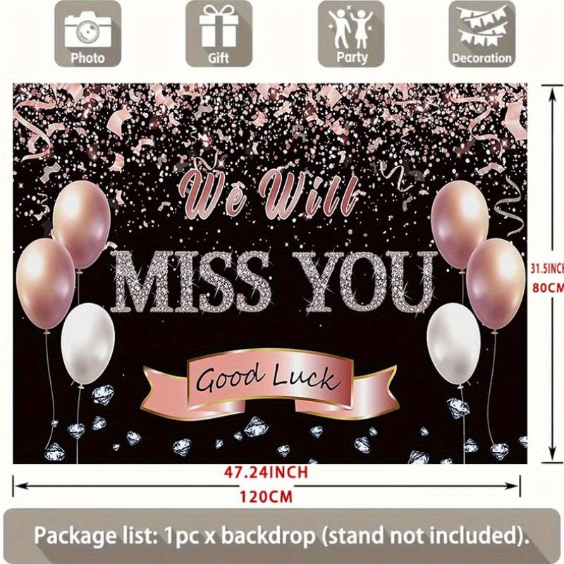 A photo backdrop for a retirement farewell celebration featuring a rose gold banner that reads "We will miss you"
