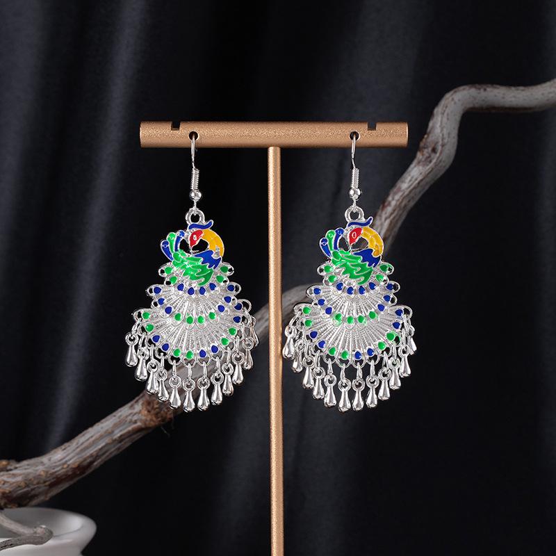 Bohemian Ethnic Miao Silver Tassel Earrings with Butterfly, Peacock, and Flower Design for Women – Long Dangle Jewelry for Travel Photos.