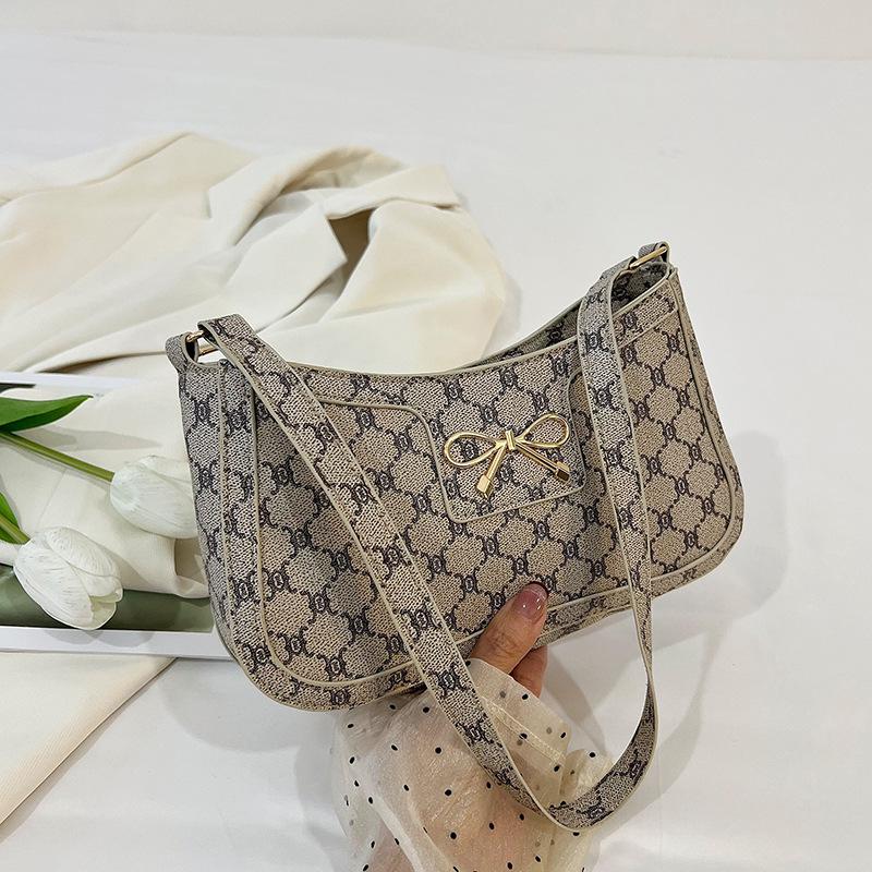 

Korean version of splicing personalized trendy texture fashion bow 2025 spring new foreign style commuter underarm shoulder bag women хаки