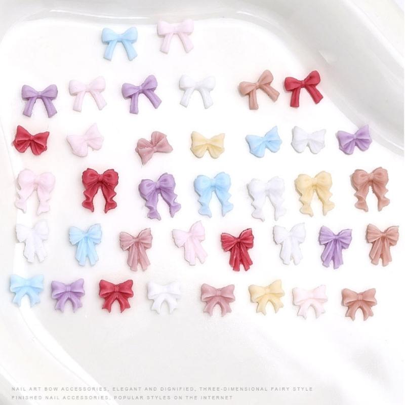 50 Stück Schleifen Nagelanhänger Einfache Schleife Nagelkunst Dekorationen Schleifen Designs Nagelzubehör Harzschleifen Nagel Strasssteine Geschenke