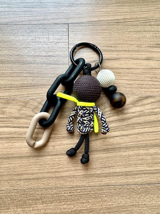 

SATTCHI BR KNOT DOLL CHARM brown