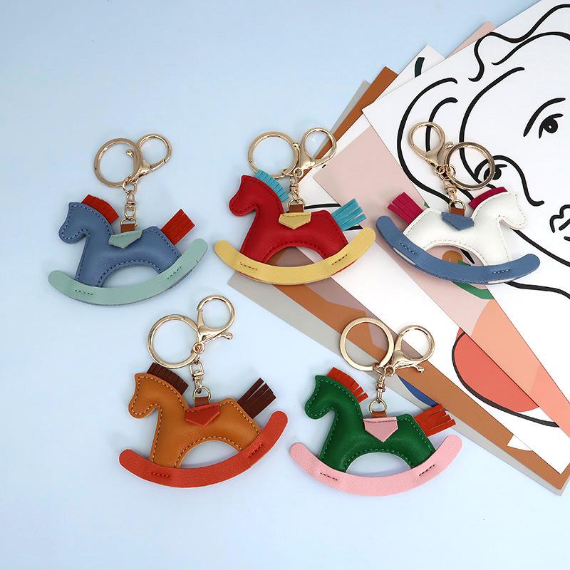 Cartoon Rocking Horse Keychain: Creative PU Leather Pony Charm with Cotton Filling.