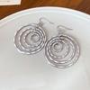 Bohemian round thread hollow multi-layer ear hook European and American cold wind earrings light luxury high-end earrings