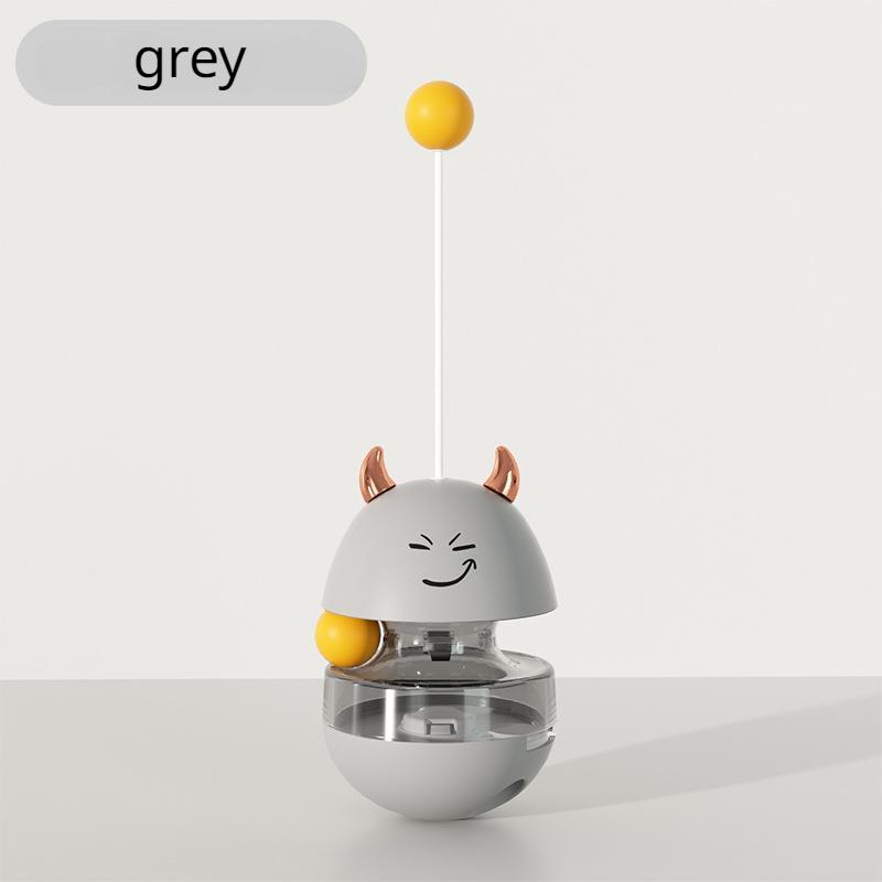 Ein süßer Becher, der Katzenfutter fallen lässt, um mit Katzen zu spielen