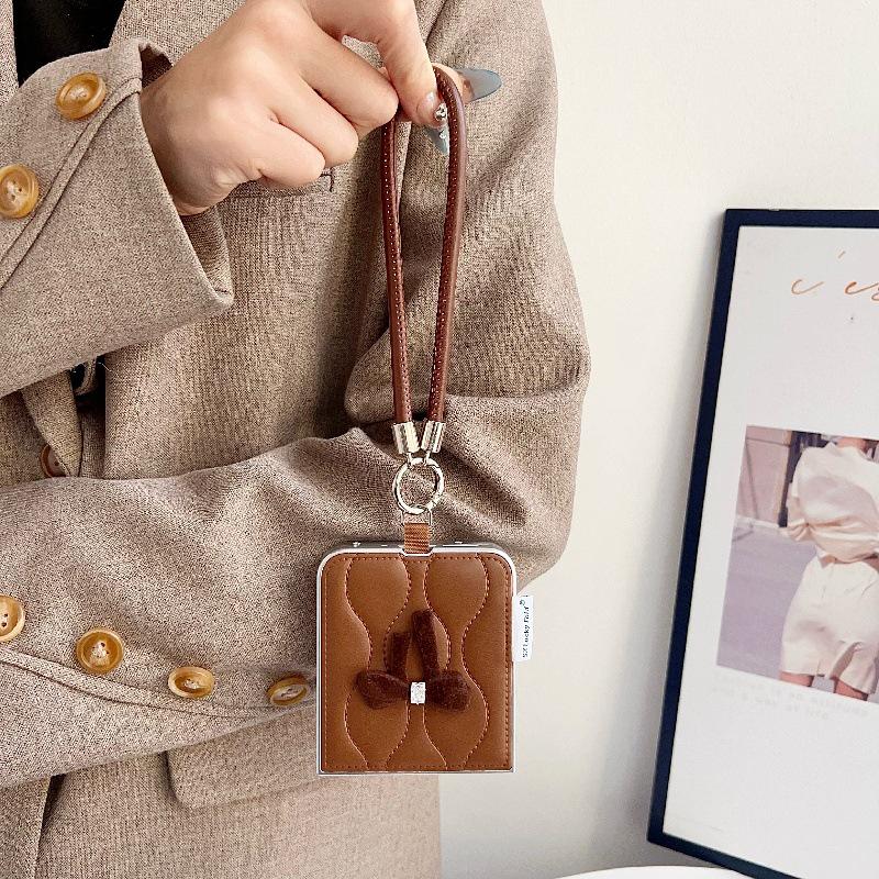 Fashionable Bowknot Motorola Razr60 Drop-proof Foldable Phone Case with Anti-lost Rope.