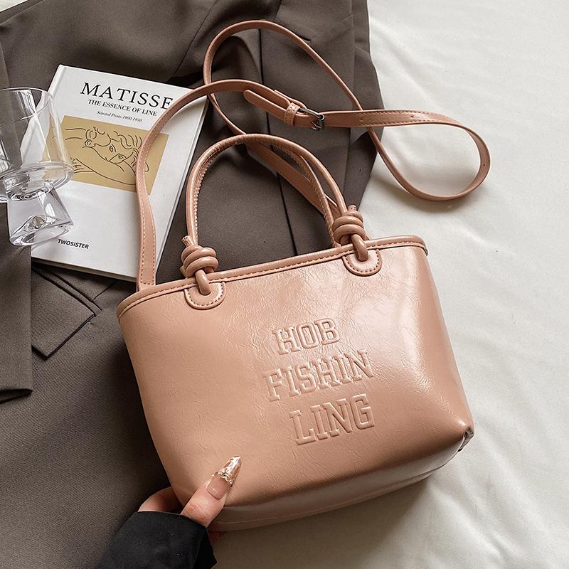 

2025 popular new niche simple wind hand carrying bucket bag Korean version casual versatile commuter fashion messenger bag women