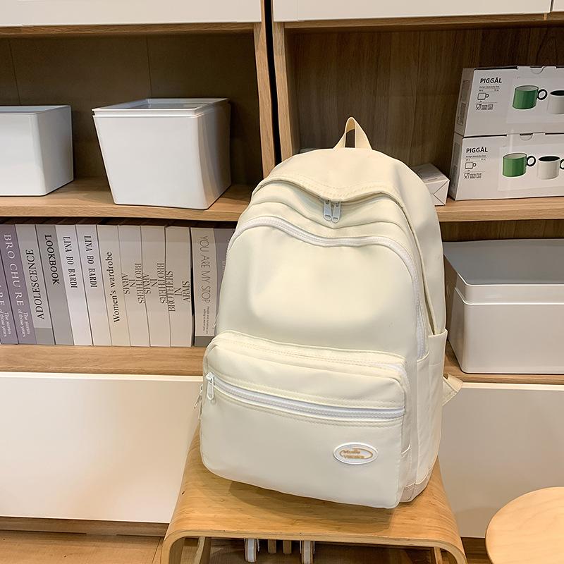 New Tide Simple Solid Color Light Leisure Backpack High Value Junior High School Students Large Capacity Backpack.