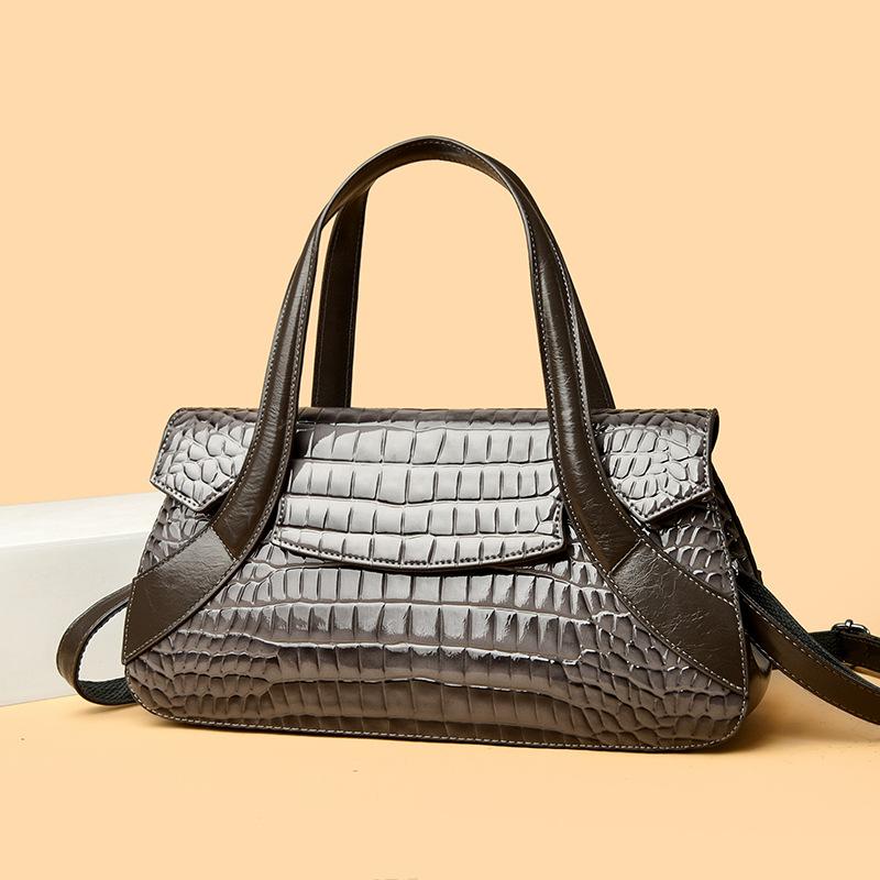 Diese Handtasche ist eine Damenhandtasche mit großem Fassungsvermögen und Krokodilmuster.. Es kann in der Hand, über der Schulter oder als Umhängetasche getragen werden.