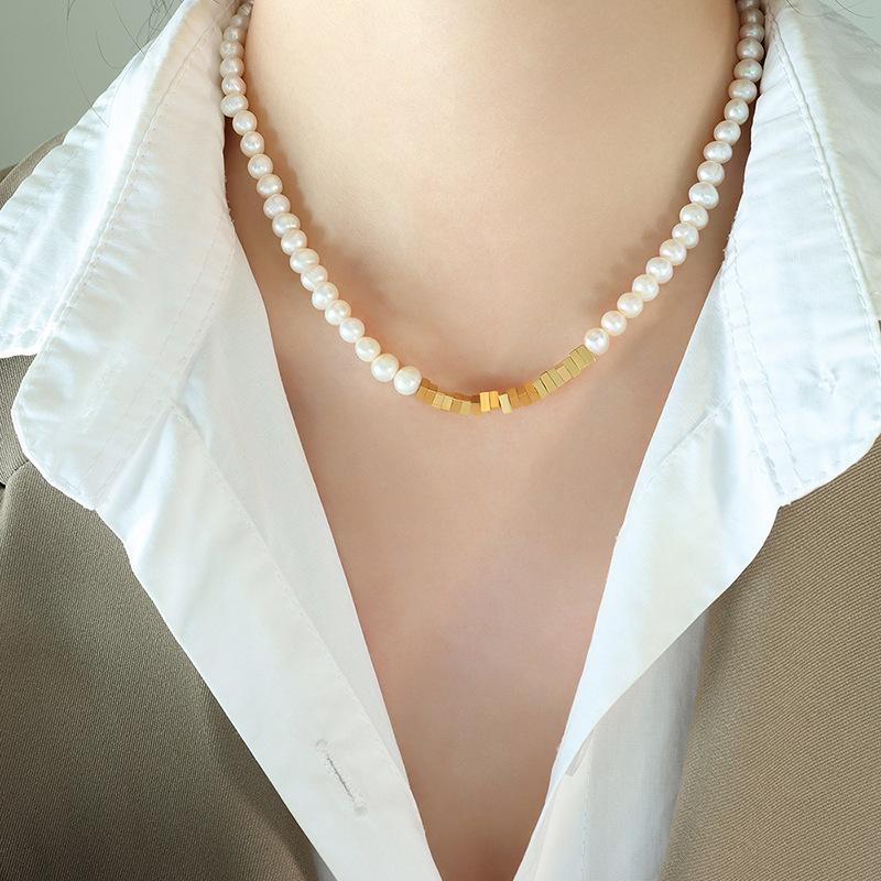 Meier French-inspired, trendy, and chic triangle pendant necklace with freshwater pearl accents