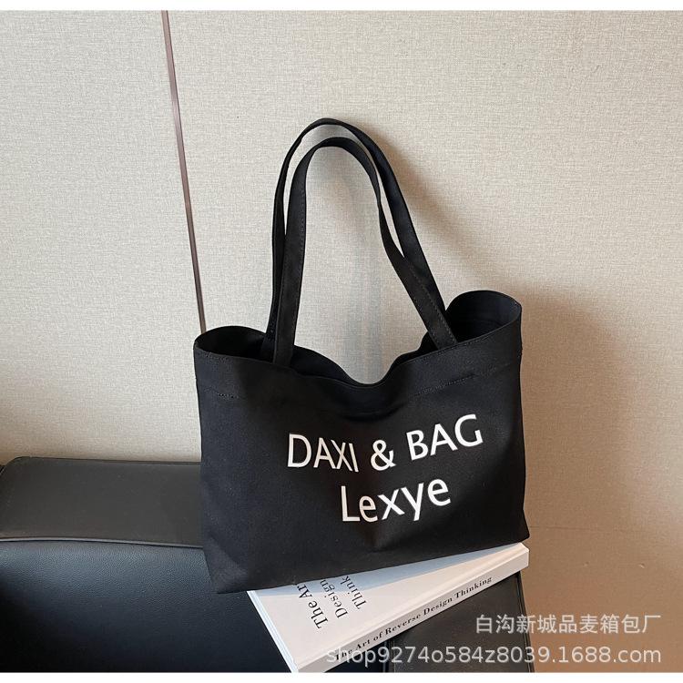 

Letter printed canvas bag women s 2025 new summer fashion tote bag college wind large capacity shoulder bag tide