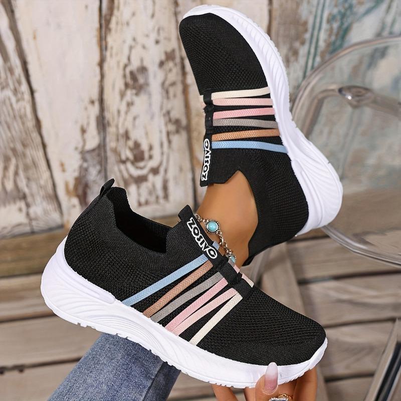 The Lady Wears Slip-On Casual Sports Shoes, Featuring a Breathable Mesh Design with Pastel Stripes, Suitable for Tennis And Comfortable