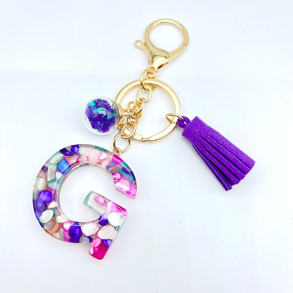 Europäischer und Amerikanischer Bestseller Englischer Initialschlüsselanhänger mit Lila Quasten-Accessoire