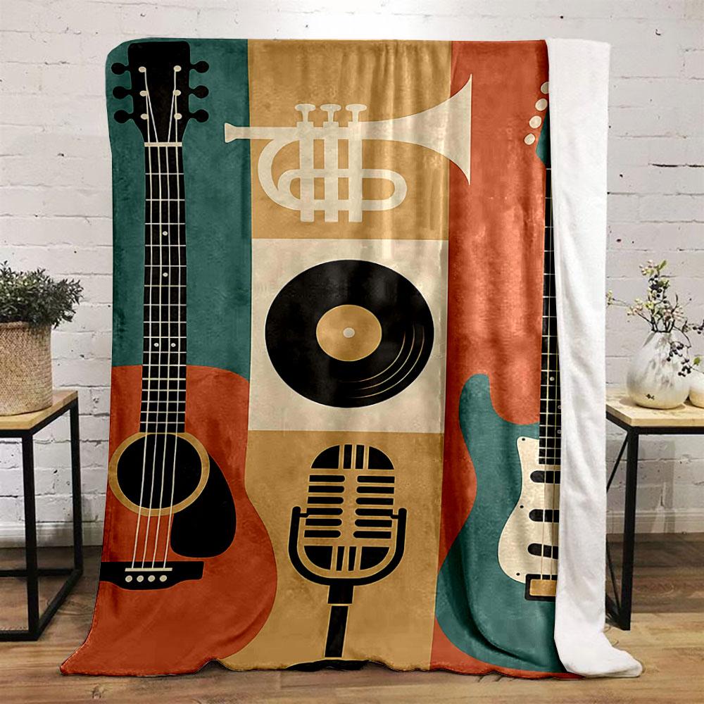 The pattern features guitars, a trumpet, a microphone, and a vinyl record. for all seasons blanket lunch break throw gift