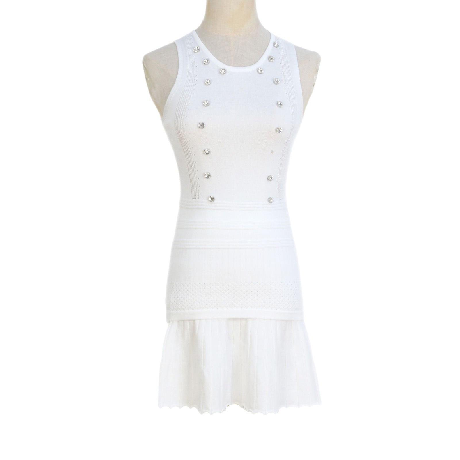 

Приталенное платье-футляр без рукавов и плиссированная вязаная юбка Large