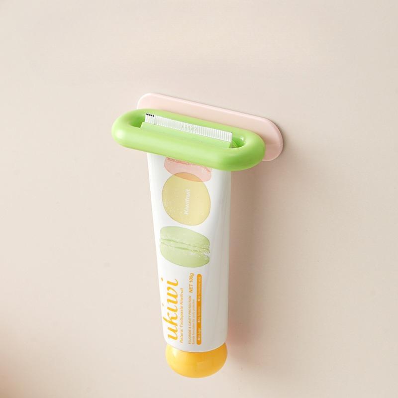 

Lazyman s Toothpaste Dispensing Tool - Handheld Manual Facial Cleanser Wall-mounted Toothpaste Dispenser рожевий/зелений