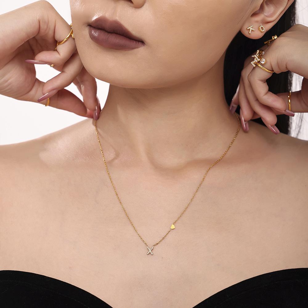 Qiong Yao 26-Letter Zircon Inlaid Jewelry Set: Gold-Plated Titanium Steel Necklace, Bracelet, Ring, and Stud Earrings.