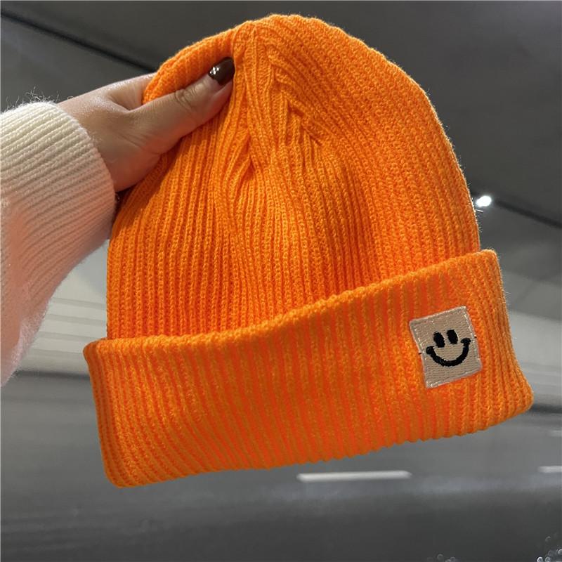 Cute smiley face label wool hat women's autumn and winter warm trend versatile ear protector black knitted hat men