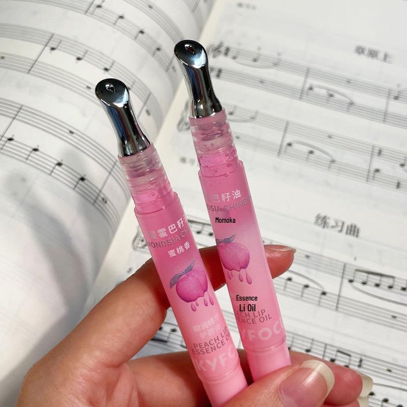 PinkyFocus Sweet Nourishing Lip Oil Hydrates and Smooths Lips, Reducing Lip Lines with a Peach Gloss Finish.