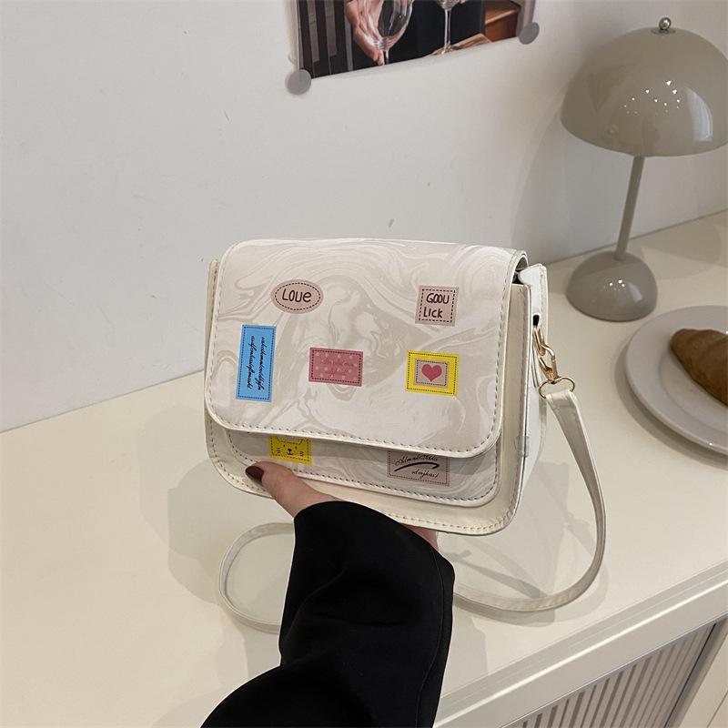 Versatile and foreign style spring new simple small square bag women's fashion high sense temperament light luxury design messenger bag