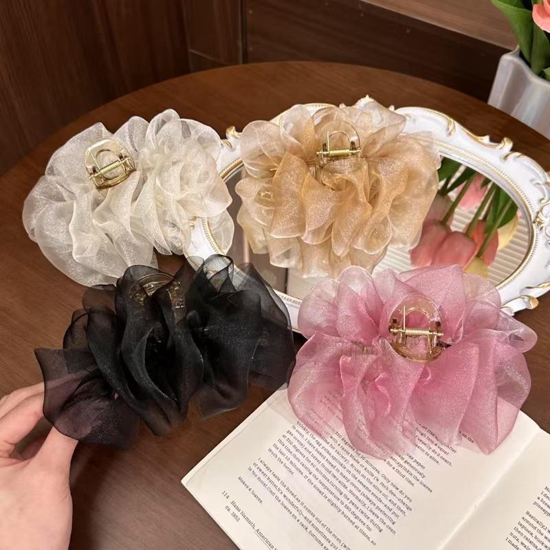 The Mesh Grabber Is Elegant and Feminine with A Lot of Hair On The Back of The Head. It Is A Shark Clip Hair Accessory