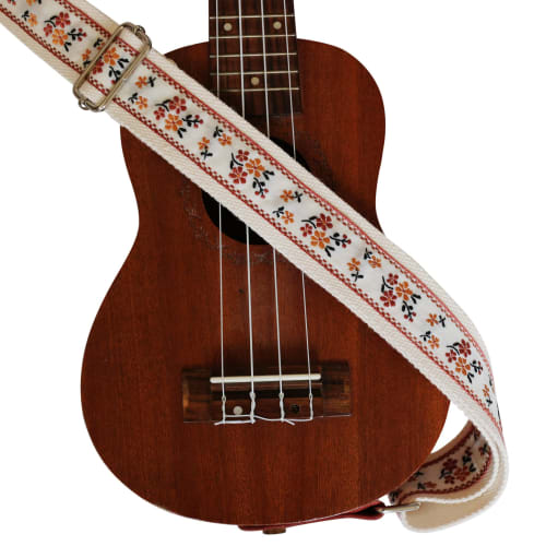 This is a genuine leather ukulele strap with a vintage floral embroidery, an original design by MUSIC FIRST. It is a ukulele shoulder strap with a gen